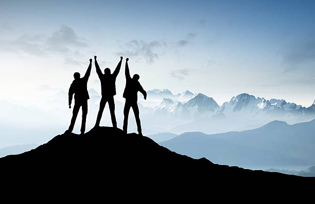 Silhouettes of a team Silhouettes of a team on mountain peak. Sport and active life concept high section stock pictures, royalty-free photos & images