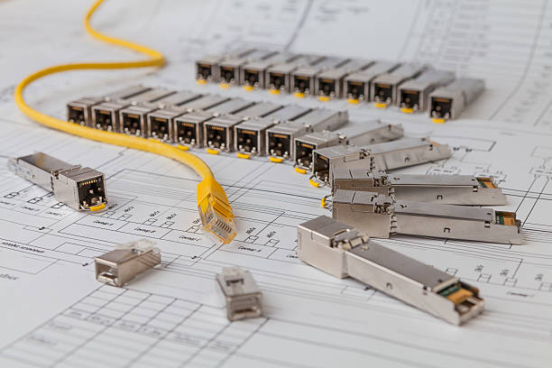 SFP network modules for network switch  and patch cord Electric gigabit sfp modules for network switch on the blueprint of  communication equipment and patch cord computer plan fiber optic engineer stock pictures, royalty-free photos & images