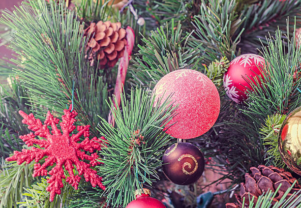istock Christmas tree vibrant colored ornaments, globe hanging, snow fl 517130762