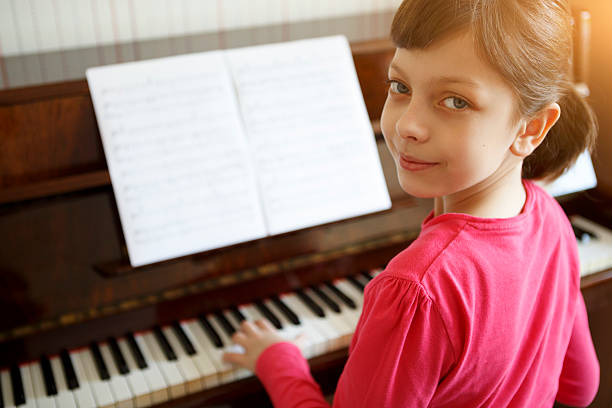 istock Girl playing piano 517131642