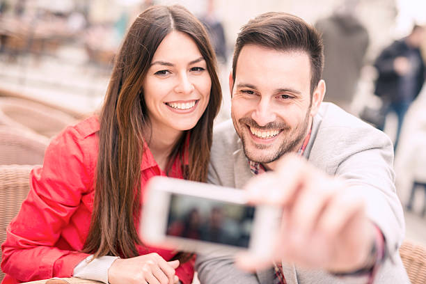 istock Young couple taking a selfie 517133752