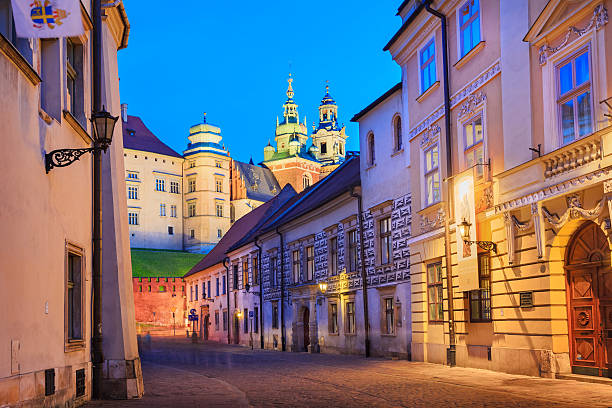 Krakow, Poland - June 10, 2010: Alley leading toward the landmark Wawel Castle in Old Town Krakow, Poland with the Archdiocesan Museum in the foreground.