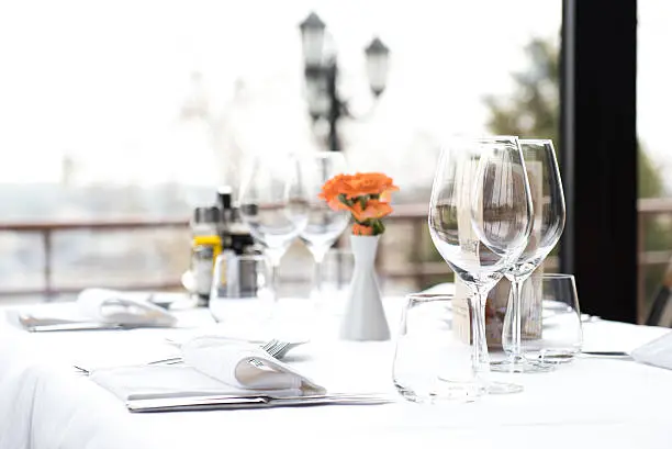 A restaurant dining table & dinner place setting. Restaurant Dinner Table Place Setting, Napkin & Wineglass