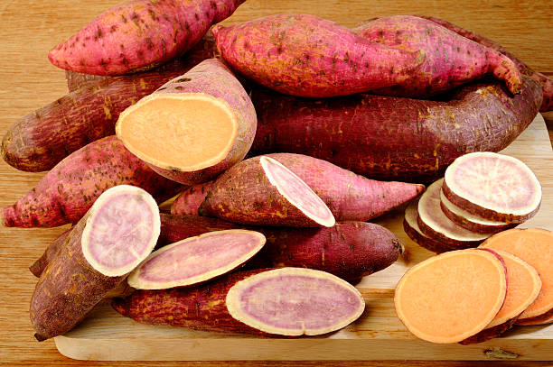 istock Raw sweet potatoes on wooden background 517135567