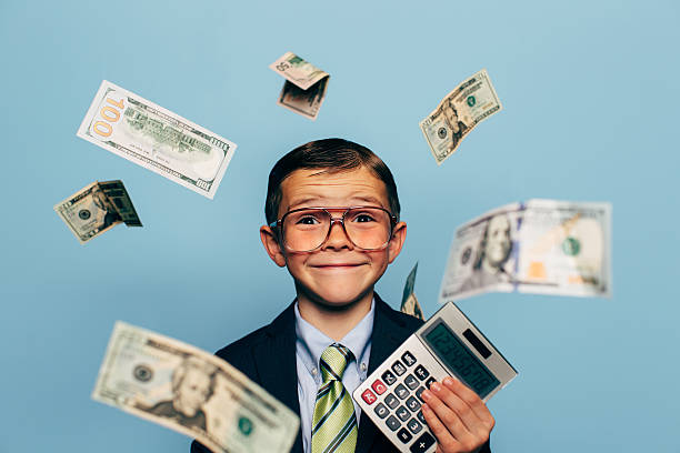 istock Young Boy Accountant Wearing Glasses holding Calculator 517135704