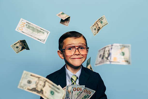 istock Young Boy Accountant Wearing Glasses with Falling Money 517135720
