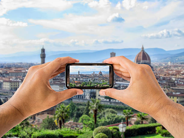 istock tourist holds up camera mobile at Florence 517136735