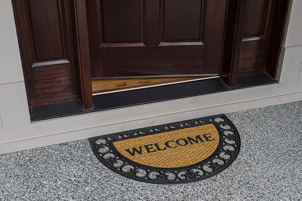 istock Welcome door mat with open door 517137503