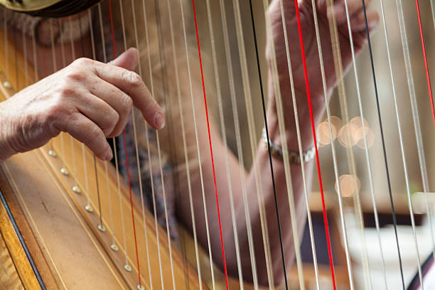 istock Woman playing harp 517137527