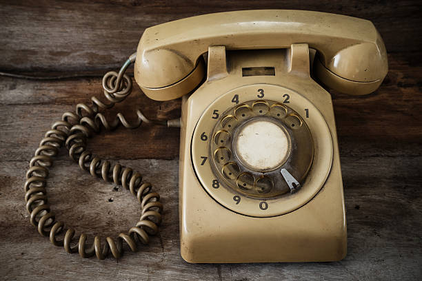 istock Vintage Telephone on an Old Wood Table 517137605