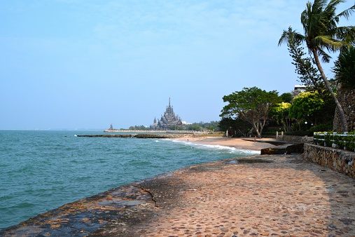 Nakluea beach and the Sanctuary of Truth in the background, an all-wood temple construction filled with sculptures based on traditional Buddhist and Hindu motifs. 