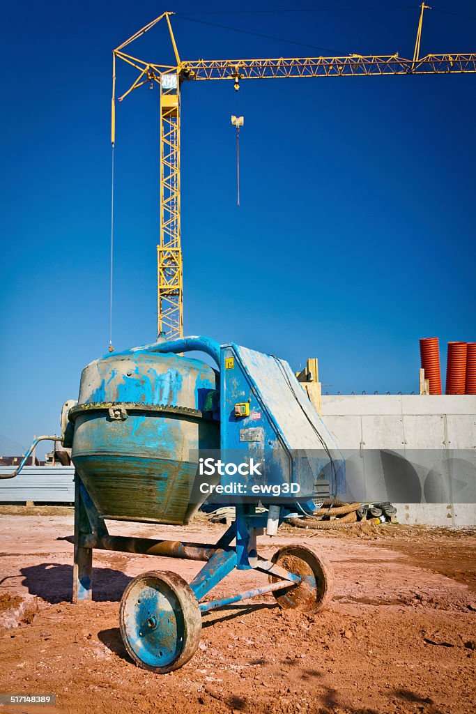 Construction - On Site Blue cement mixer at a construction site of a new apartment building Apartment Stock Photo
