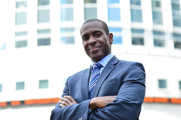 istock Confident businessman with arms crossed 517148409