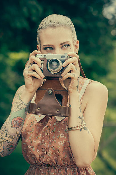 istock Blonde woman with the vintage rangefinder 517148697