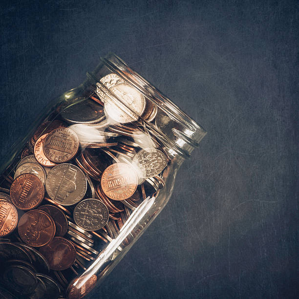 istock Full Money Jar against Scratched Chalkboard 517150359