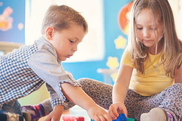istock Boy and girl playing with plastic cubes 517151190