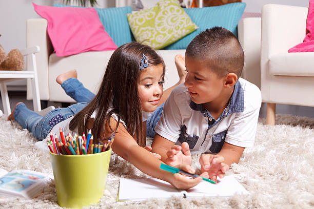 Two young children learning at home stock photo