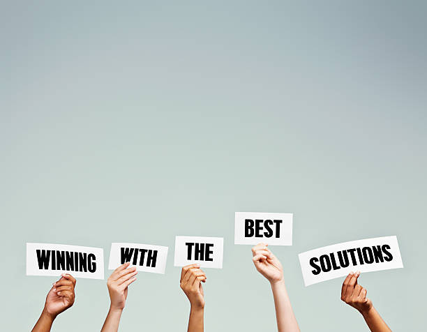 istock Winning with the best solutions claim hand-held signs 517153935