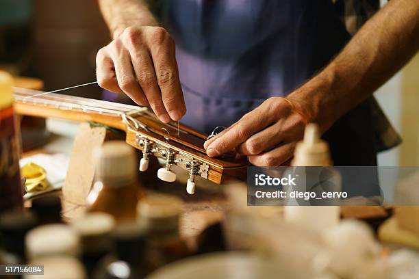 Artisan Lute Maker Fixing Stringed Instrument Replacing Guitar C Stock Photo - Download Image Now