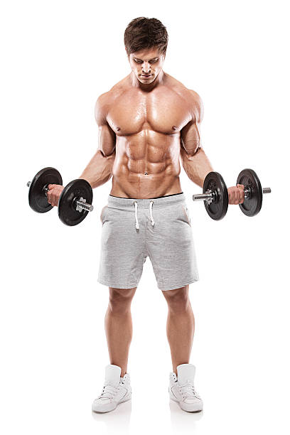 Muscular bodybuilder guy doing exercises with dumbbells stock photo
