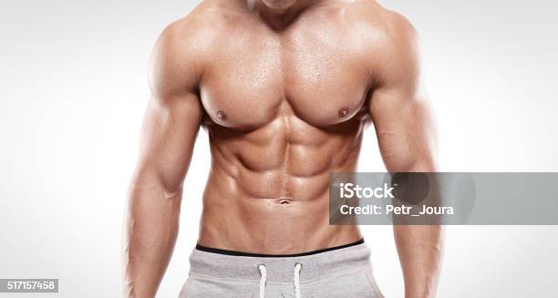 Strong Athletic Man Showing Muscular Body Stock Photo - Download Image Now - Men, Body Building, Abdominal Muscle