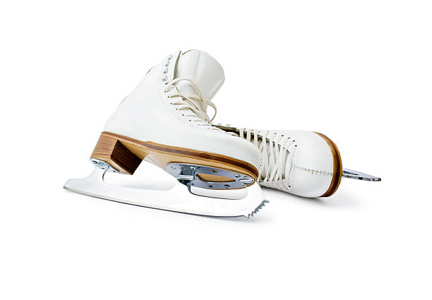 Figure ice skates Pair of professional skates for figure ice skating leaning each other close up isolated on white background. figure skating stock pictures, royalty-free photos & images