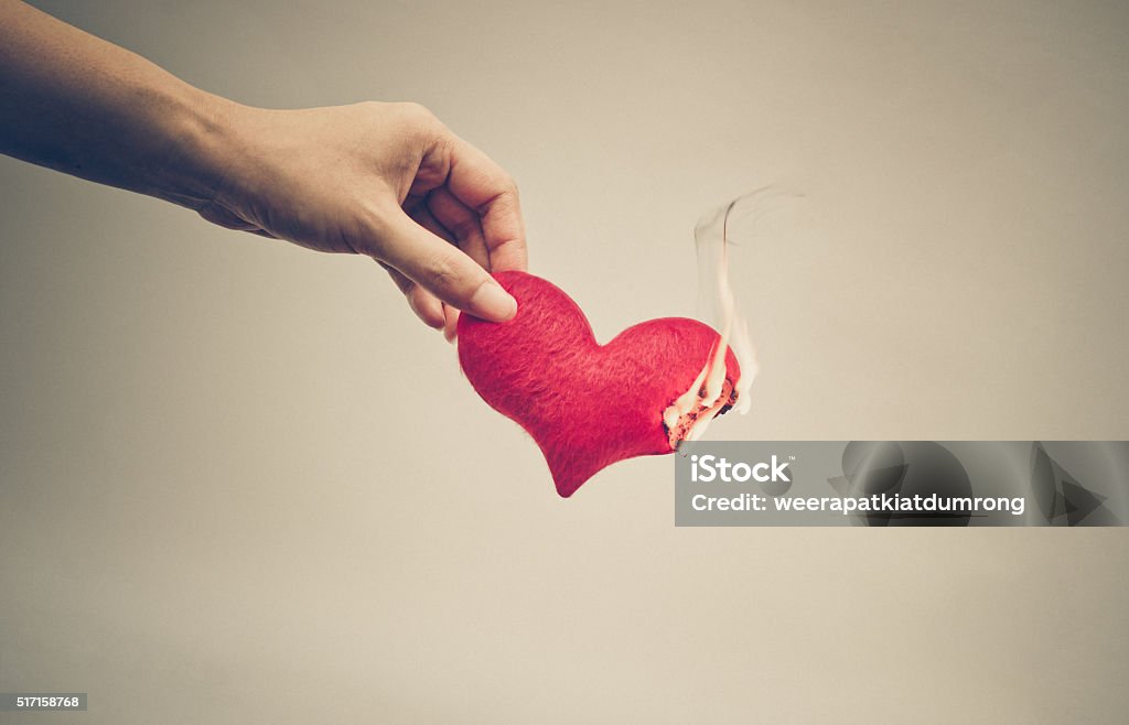Love Female hand giving a heart on fire / Dangerous love Couple - Relationship Stock Photo