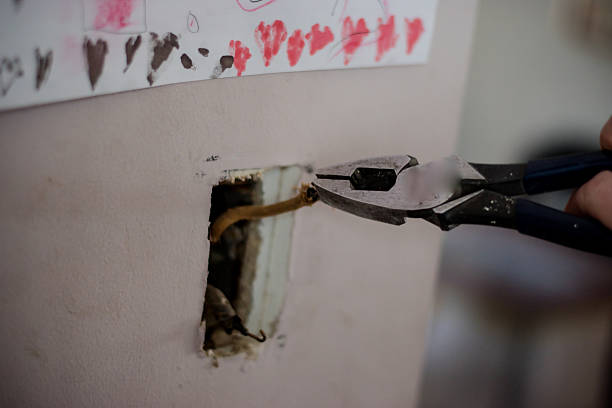 istock Wires coming from plug hole in wall 517160474