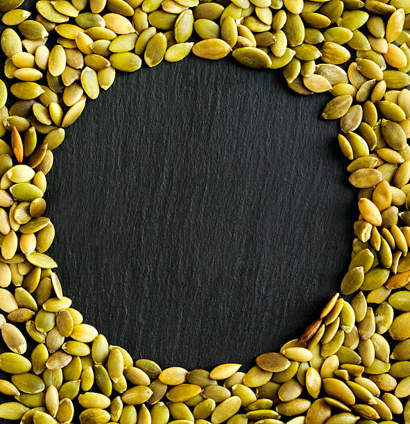 istock Copyspace background with the borders made from pumpkin seeds 517162984