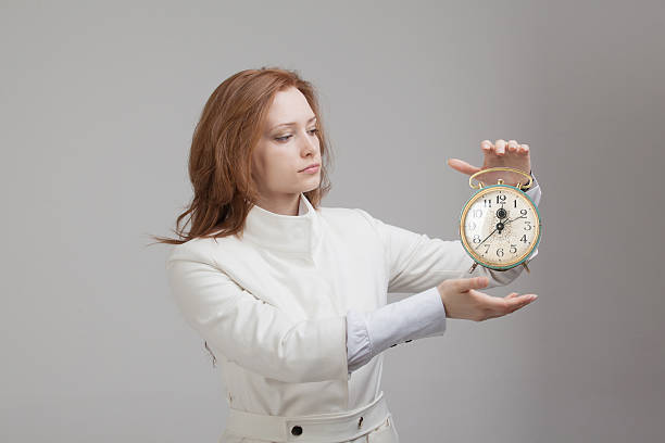 istock Attractive businesswoman showing clock 517163546
