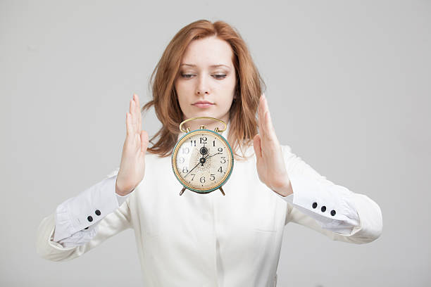 istock Attractive businesswoman showing clock 517163698