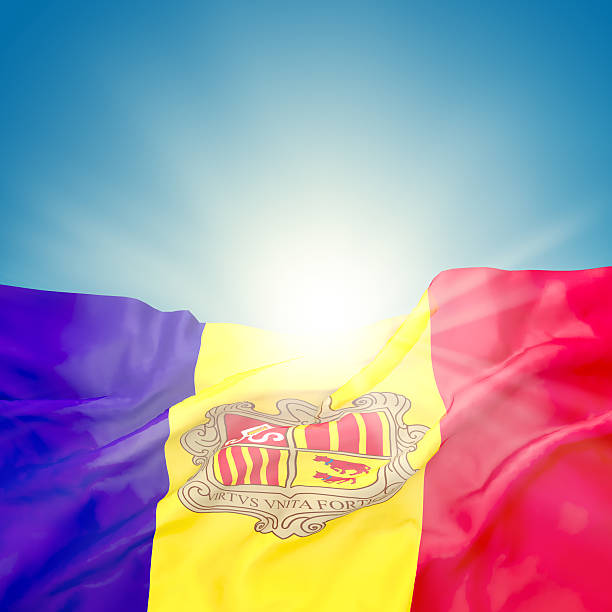 Andorra official national state flag against peaceful blue sky, rising sun and slight waving on wind