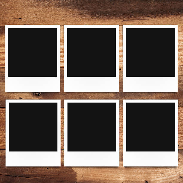 istock blank photo frames on wood background 517168485