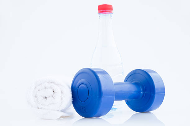 istock Blue plastic coated dumbells And Water Bottle isolated on white 517169241