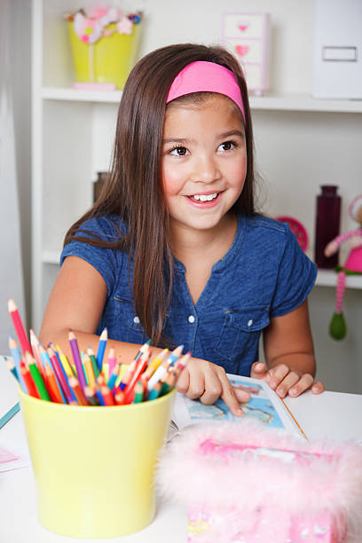 istock Cute little girl reading a book 517169671