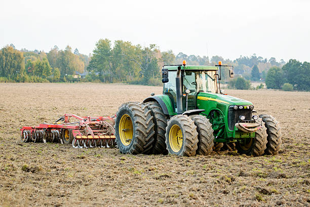 tractor en el campo de - john deer fotografías e imágenes de stock