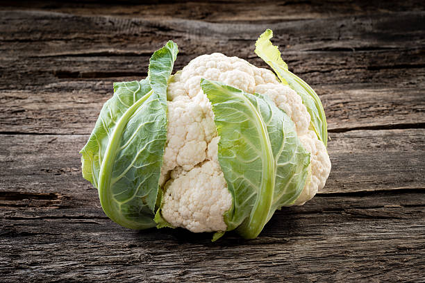 istock Fresh organic cauliflower on wooden background 517172509