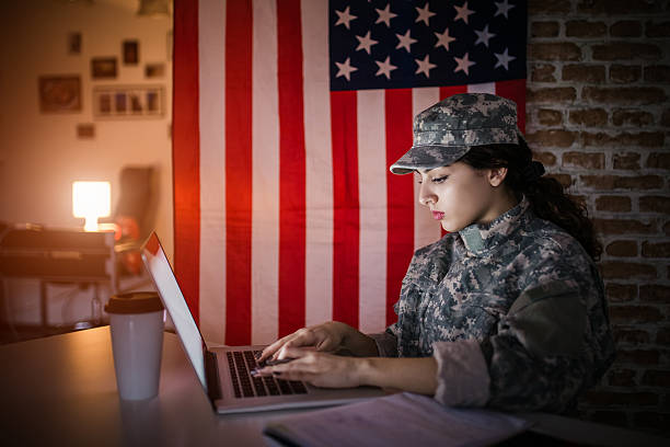 istock Female soldier using laptop in her modern office 517179332