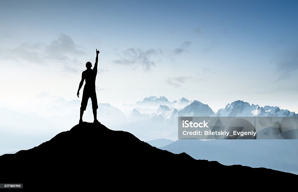 Winner silhouette Winner silhouette on the mountain top. Sport and active life concept.. Mountain Climbing Stock Photo