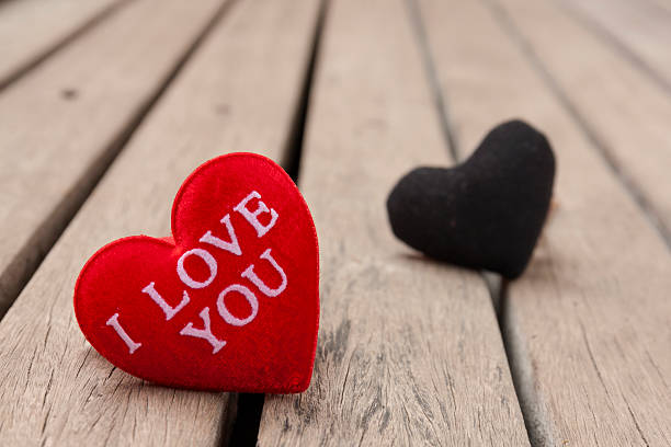 istock Red and black heart on wood floor 517185144