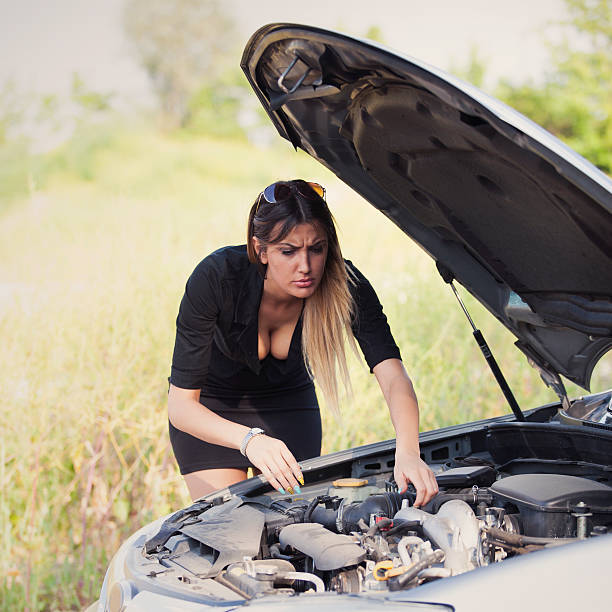 istock young woman with her broken car 517186653