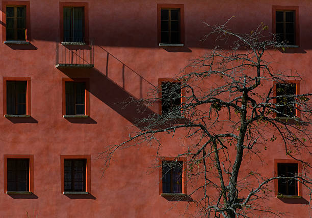 red wall with windows and balcony in Corippo, Ticino, Switzerland