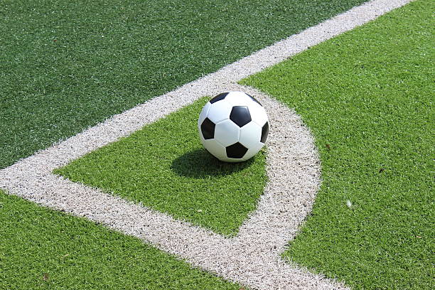 soccer ball on lawn of football field
