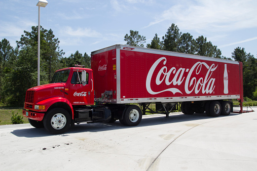 Jacksonville, Florida, USA - May 20, 2014: A red Coca-Cola truck. The Coca-Cola Company is an American beverage corporation best known for its flagship product Coca-Cola, invented in 1886 by a pharmacist.