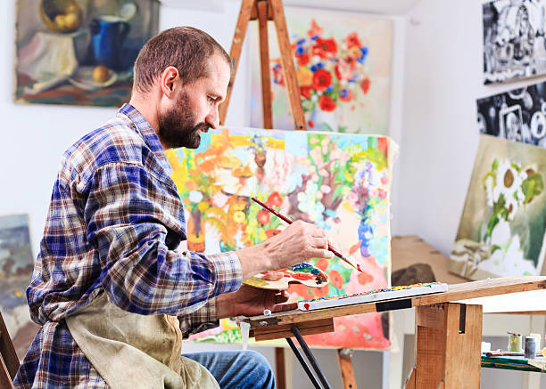 istock Artist painting in his workshop 517189876