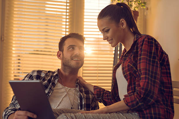 istock Smiling couple using digital tablet together at home. 517193616