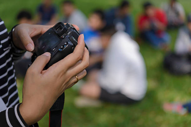 istock Asian woman holding a DSLR camera 517193634