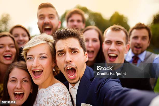 Newlyweds With Friends Taking Selfie Stock Photo - Download Image Now - Wedding, Selfie, Party - Social Event