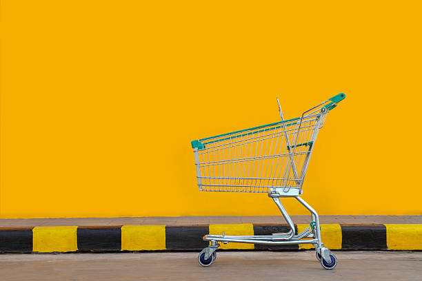 istock Shopping cart on yellow background. 517195845