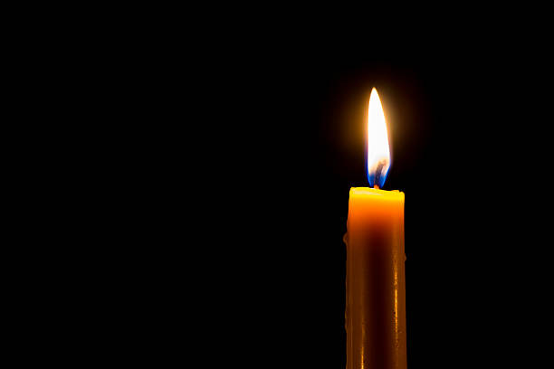 istock Yellow candle on the dark background 517197753